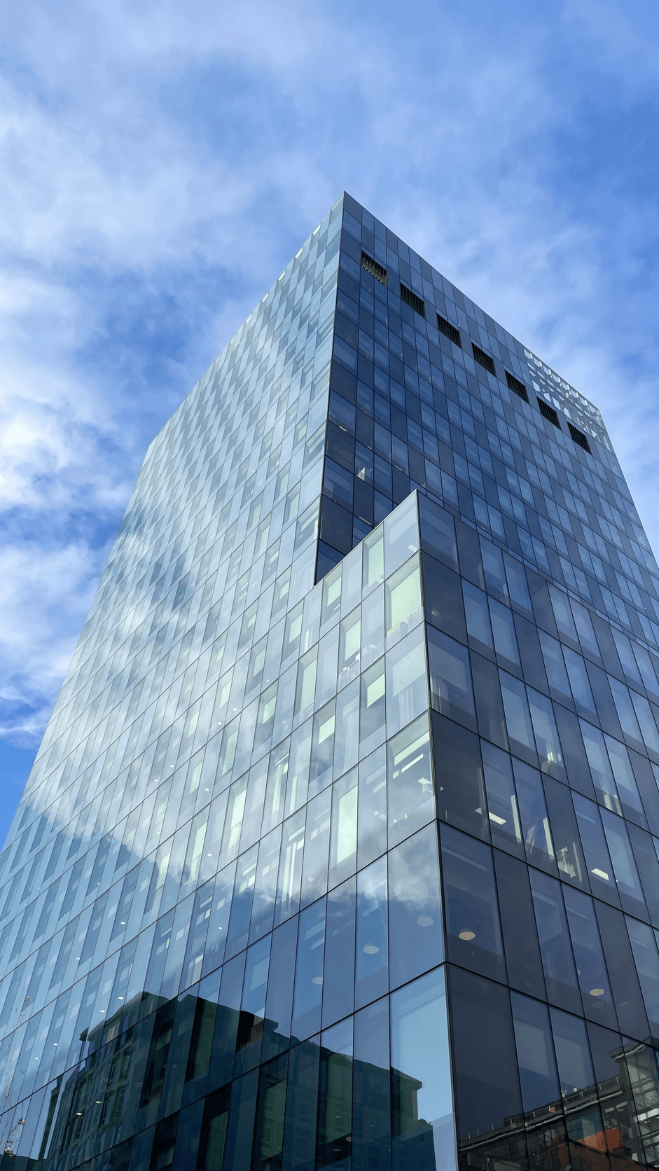 Codename Magnitude glass commercial tower against a clear sky